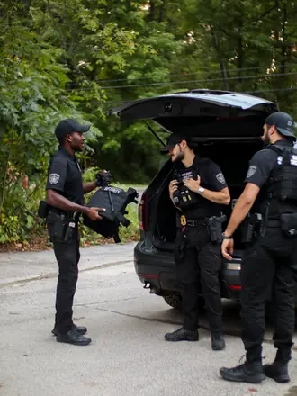 AegisPoint Security Services officers gearing up at the back of their patrol vehicle