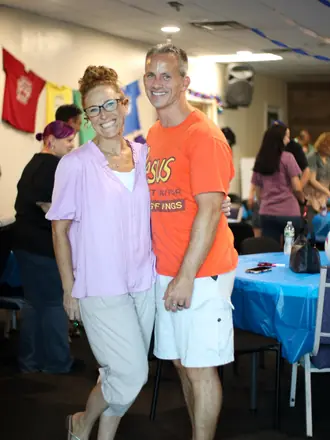 Two Matheteuo Ministries members smiling together at a church celebration