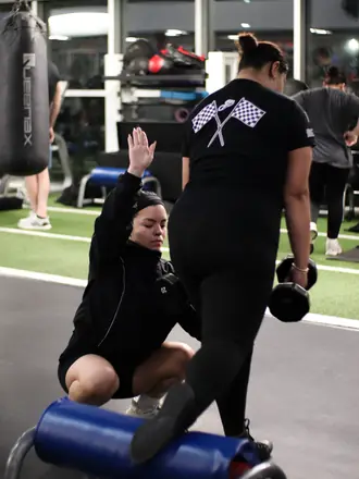 PowerHaus Fitness coach cueing a client through a lunge in a one on one session